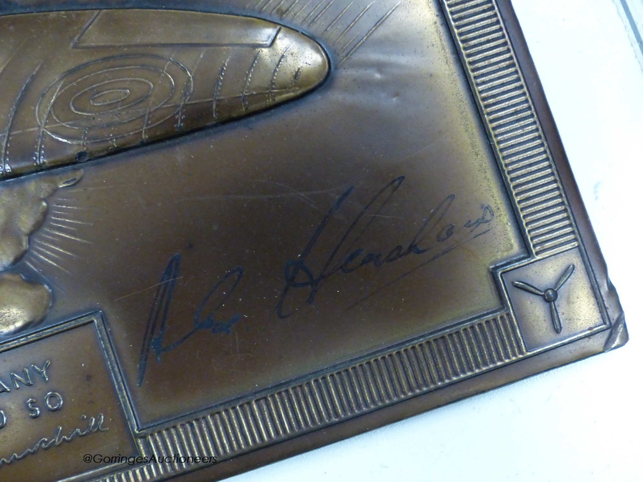 A 1941 calender, bronze finish signed by Alex Henshaw, air racer and test pilot for Vickers Armstrong